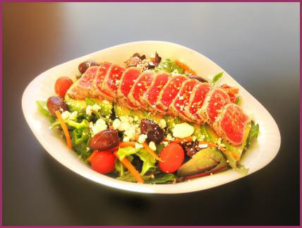 Stacked on a Baby Greens Salad, dressed-up Avocado and Lemon Stand
